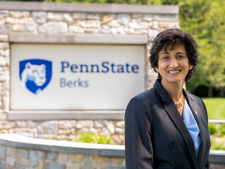 Photo of Chancellor Radha Pyati in front of Penn State Berks entrance sign